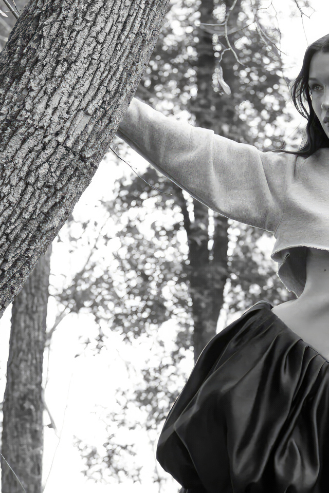 Модель Белла Хадид стоит у дерева в парке