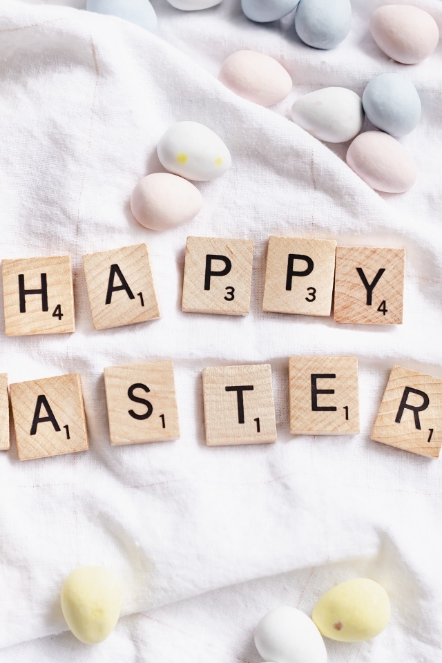 Текст  Счастливой Пасхи и пасхальные яйца на покрывале