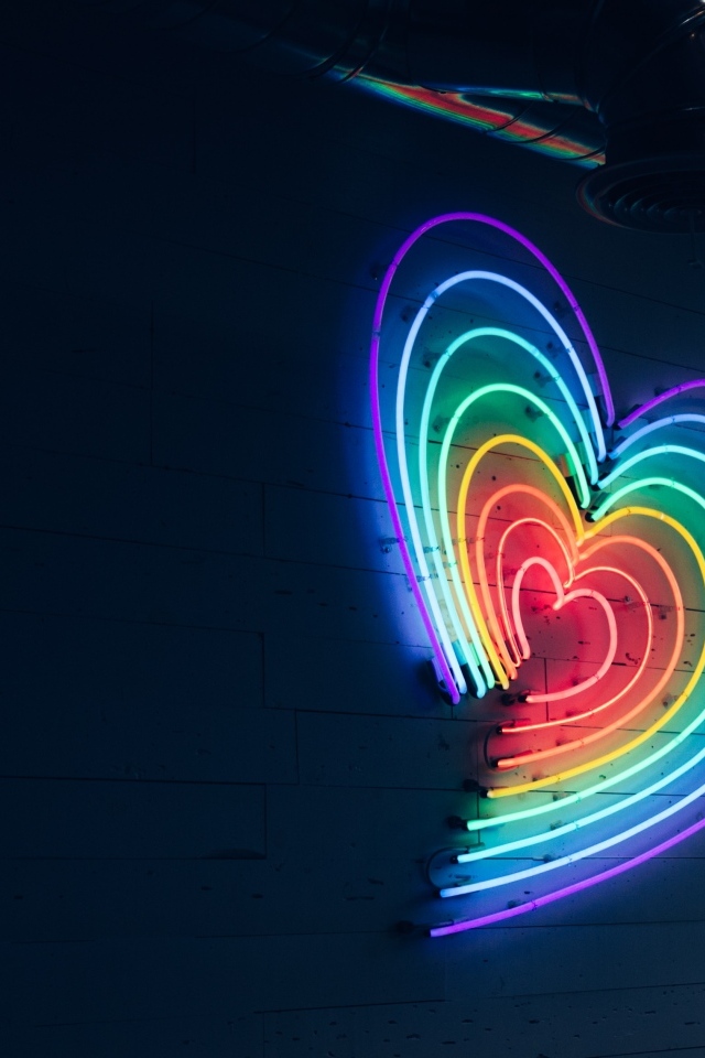 Неоновое сердце на серой стене