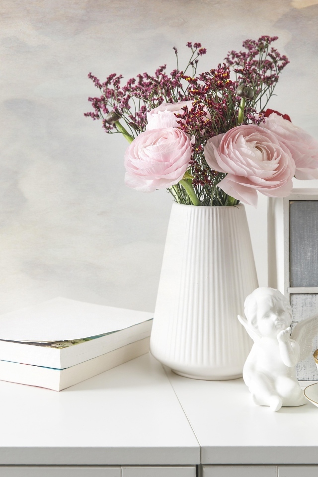 Букет розовых лютиков в вазе на столе