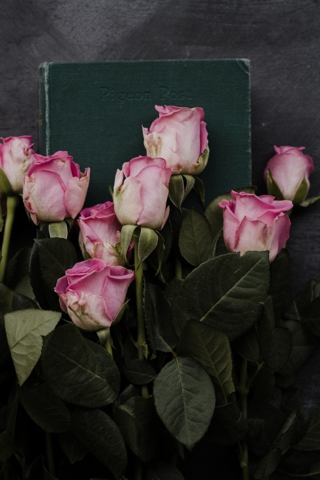 Букет розовых роз с книгой на сером столе