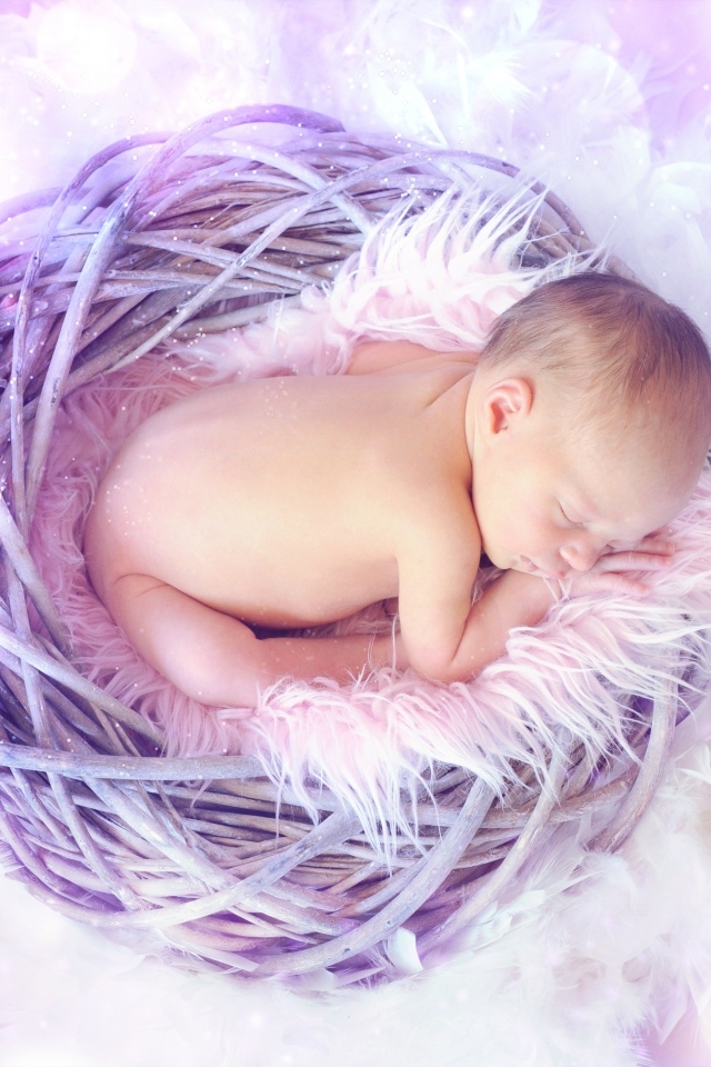 Новорожденный ребенок спит в сиреневом гнезде