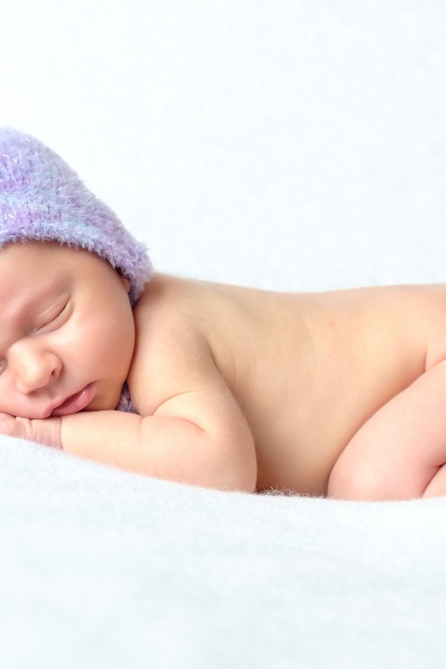 Спящий грудной ребенок в милой шапке