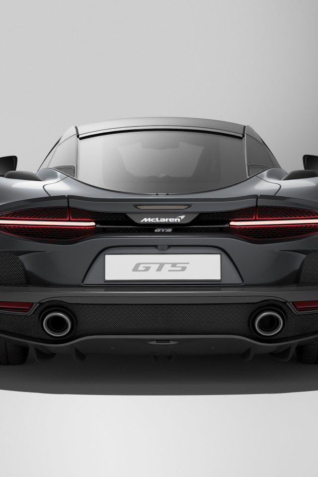 Вид сзади на автомобиль McLaren GTS на сером фоне