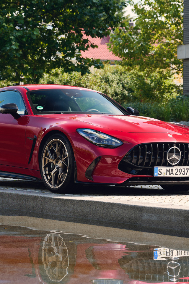 Красный автомобиль Mercedes-AMG GT 63 S E Performance 2024  года у воды