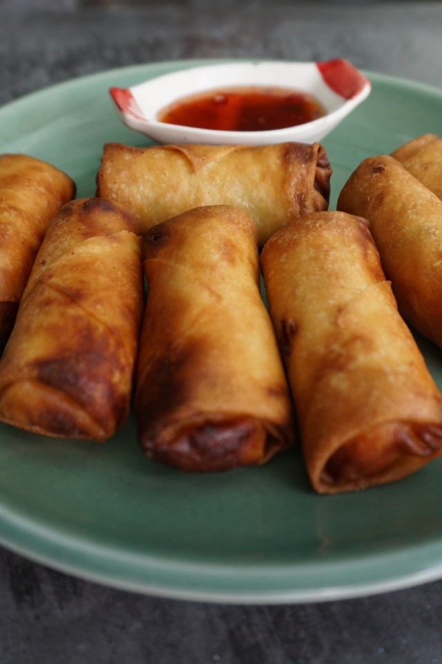 Яичные рулетики на большой тарелке с соусом