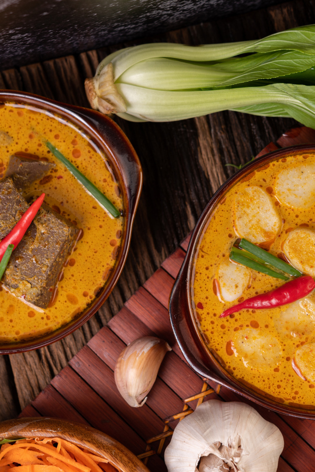 Две тарелки с острым супом на столе