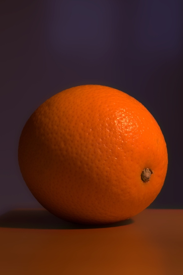 Один оранжевый апельсин лежит на столе