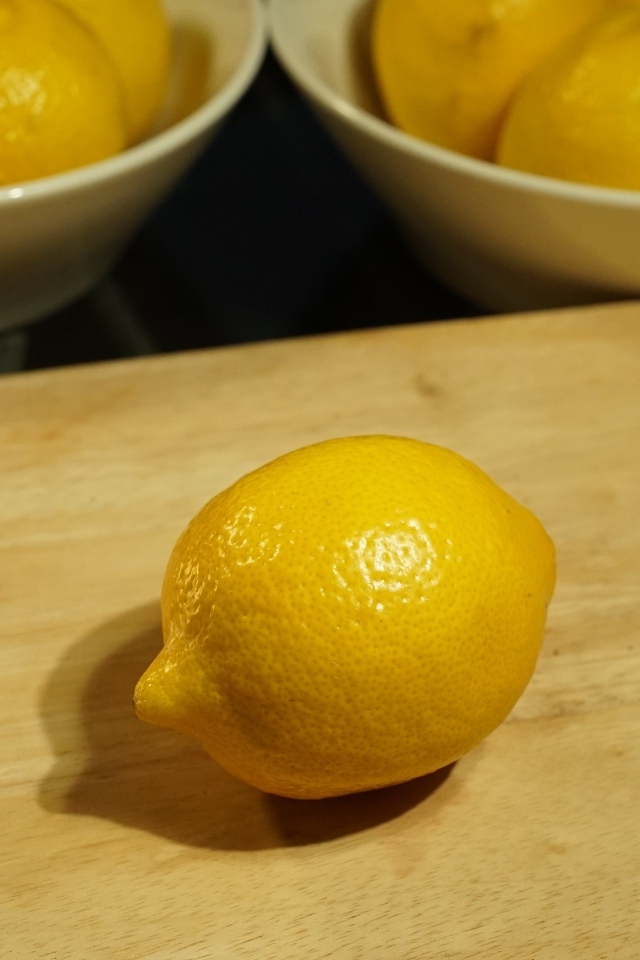 Желтый лимон на деревянной доске на столе