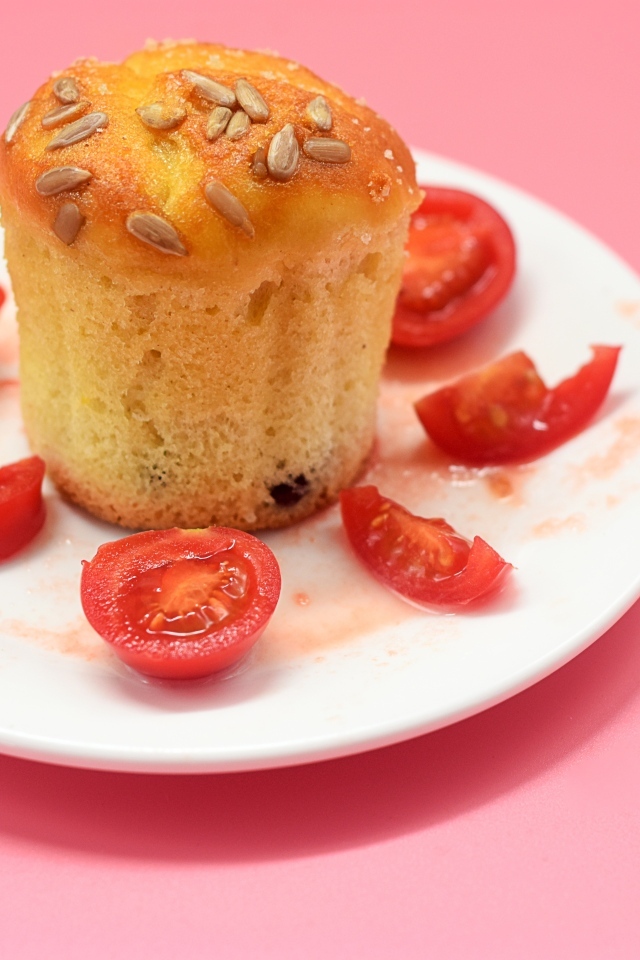 Кекс с помидорами черри на белой тарелке