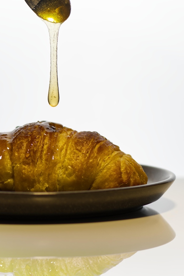 Свежий круассан с медом на завтрак