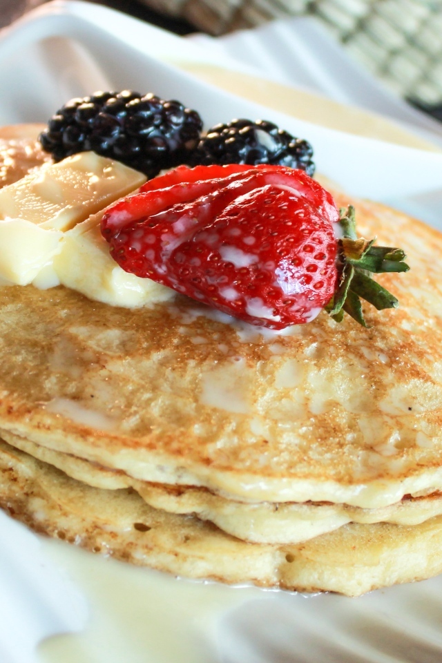 Блины с ягодами на тарелке крупным планом