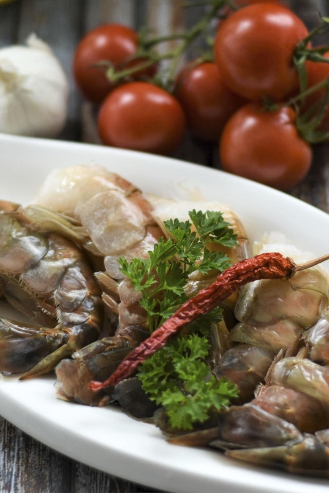 Сырые королевские креветки  на тарелке