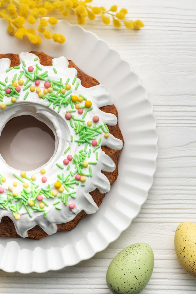 Красивый пасхальный кулич с веткой мимозы и яйцами