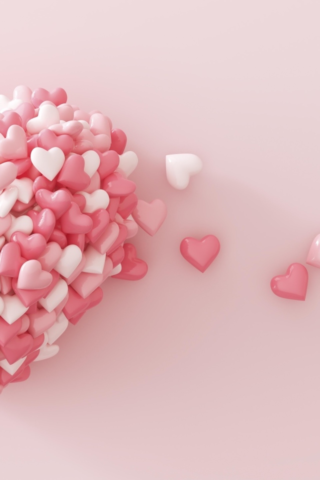 Сердце из маленьких сердечек на розовом фоне