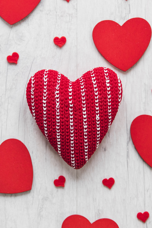 Много красных сердец на белом деревянном столе