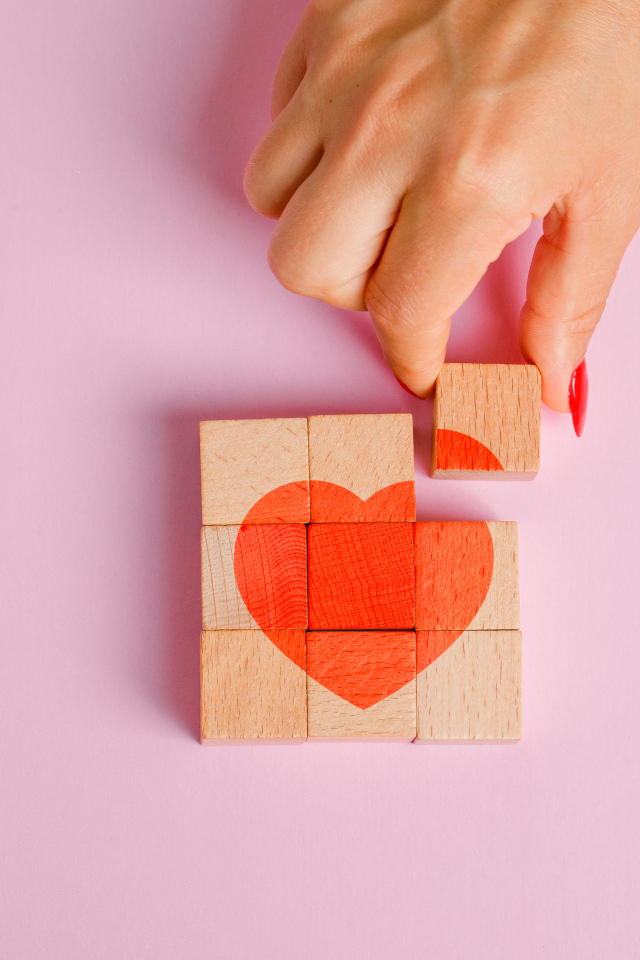 Красное сердце из кубиков на розовом фоне