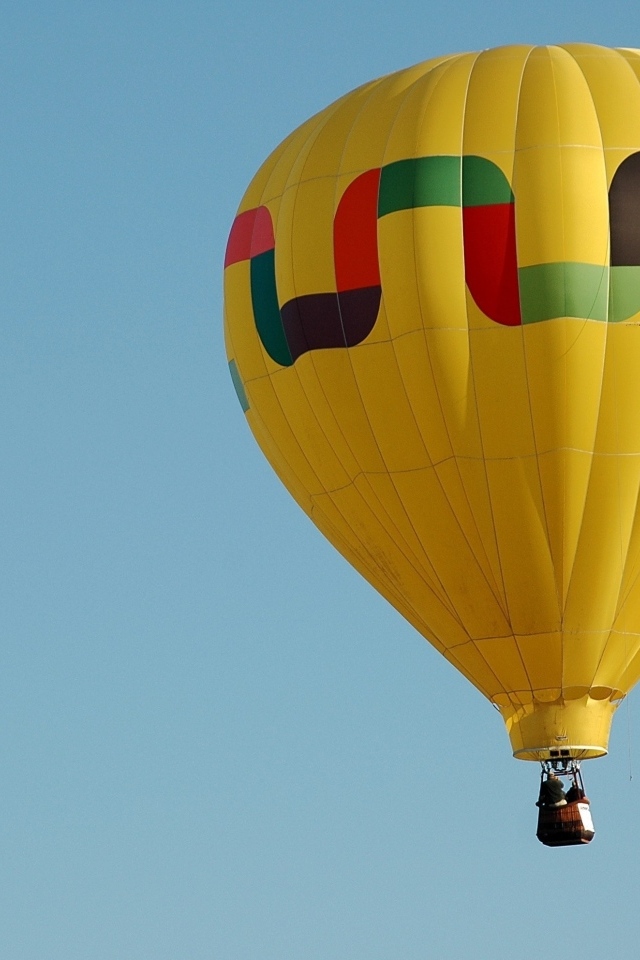 Большой желтый воздушный шар в голубом небе