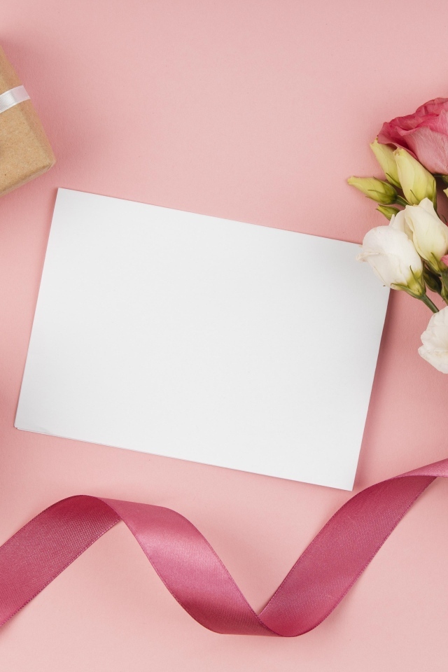 Букет эустомы с лентой на розовом фоне с подарками и белым листом