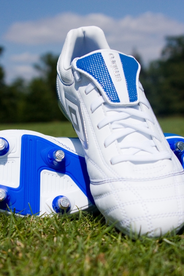 Красивые новые футбольные бутсы на зеленой траве 