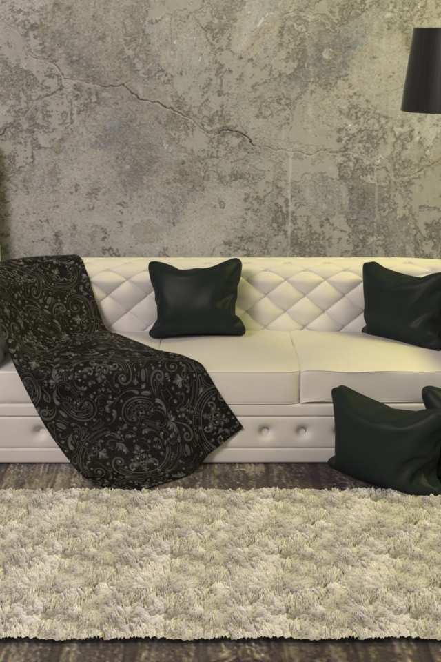 Черные подушки на белом диване в комнате с серыми стенами