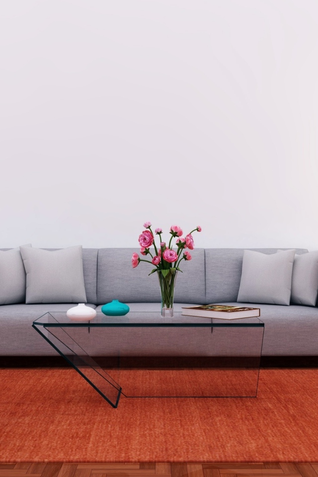 Большой серый диван в комнате с серой стеной