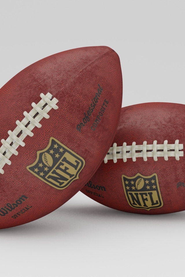 Два мяча для игры американский футбол на сером фоне