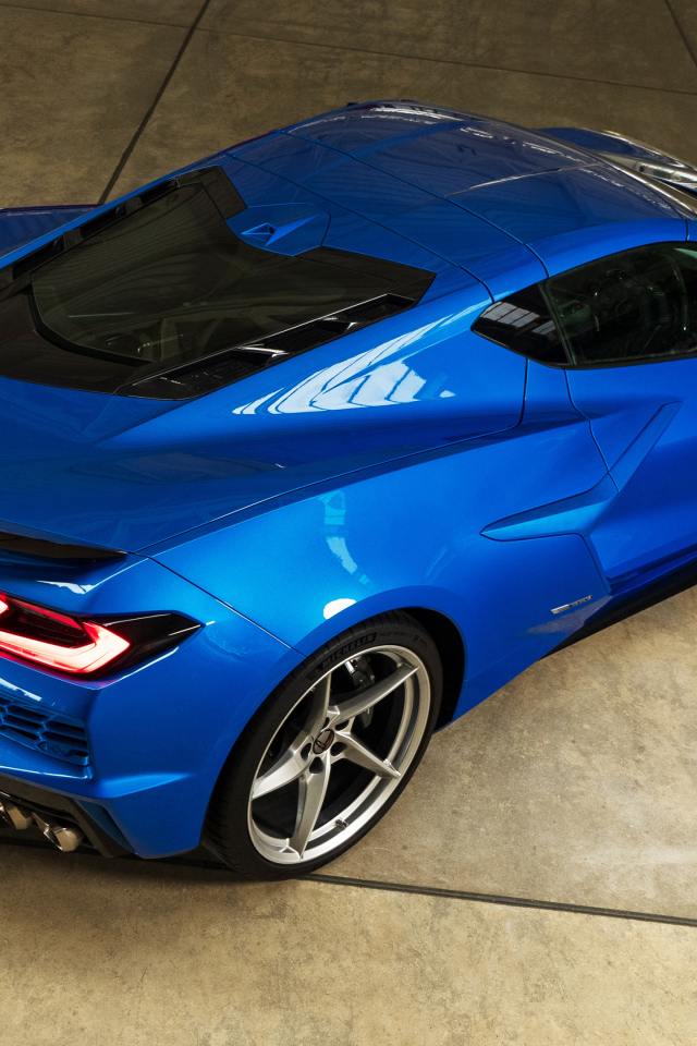Вид сзади на синий автомобиль Chevrolet Corvette E-Ray 2024 года