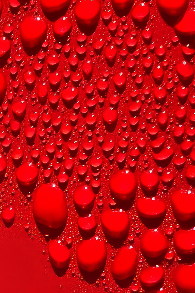 Капли воды на ярком красном фоне