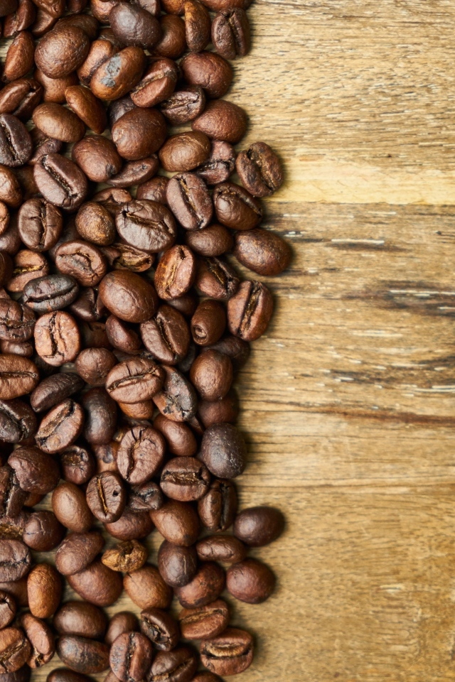 Ароматные жареные зерна кофе на деревянном столе