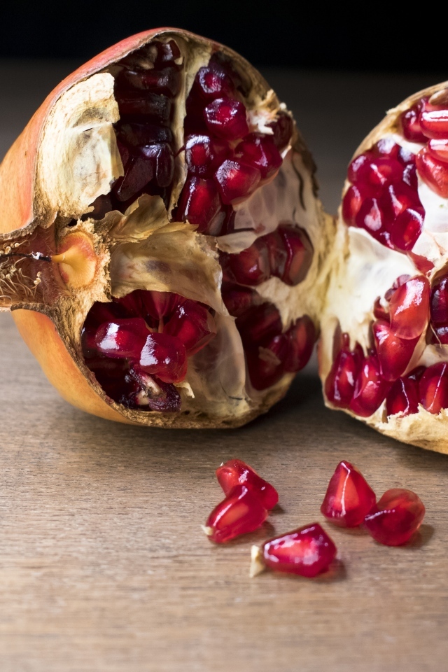 Половины плода граната на столе