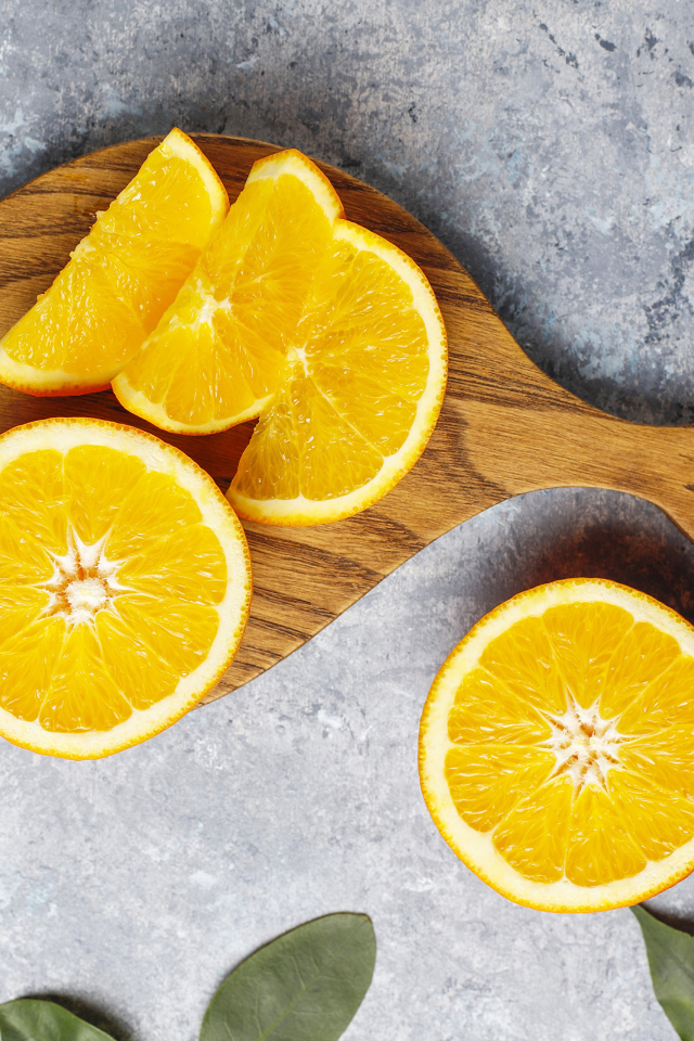 Апельсин на разделочной доске кусочками