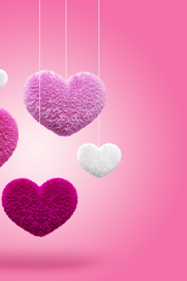 Пушистые сердечки на веревках на розовом фоне