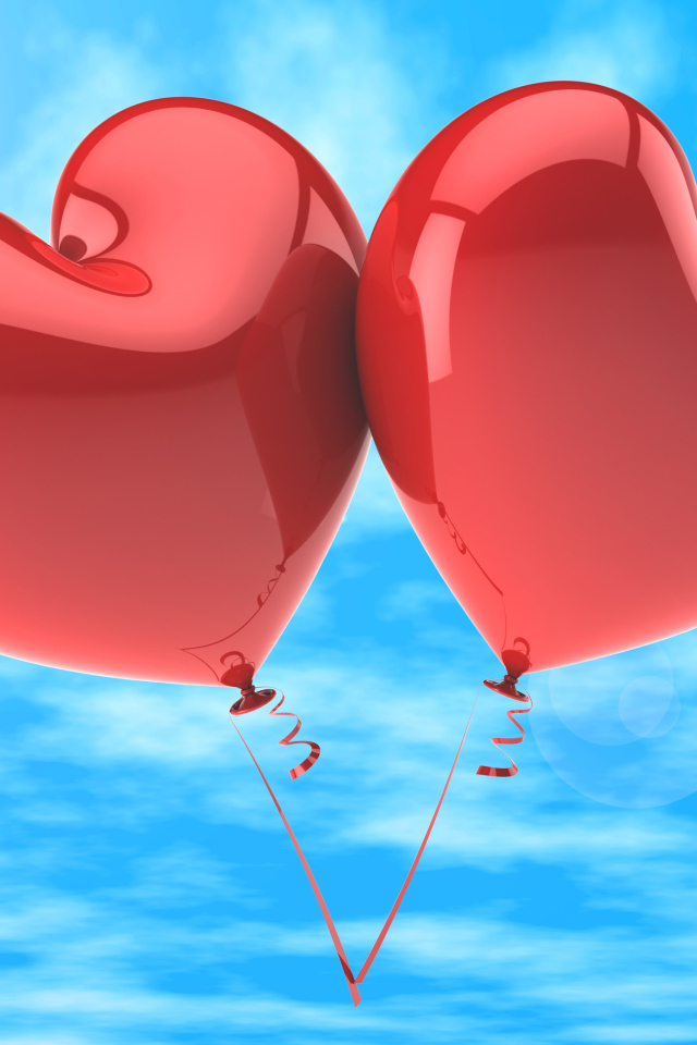 Два красных шарика в форме сердца в голубом небе