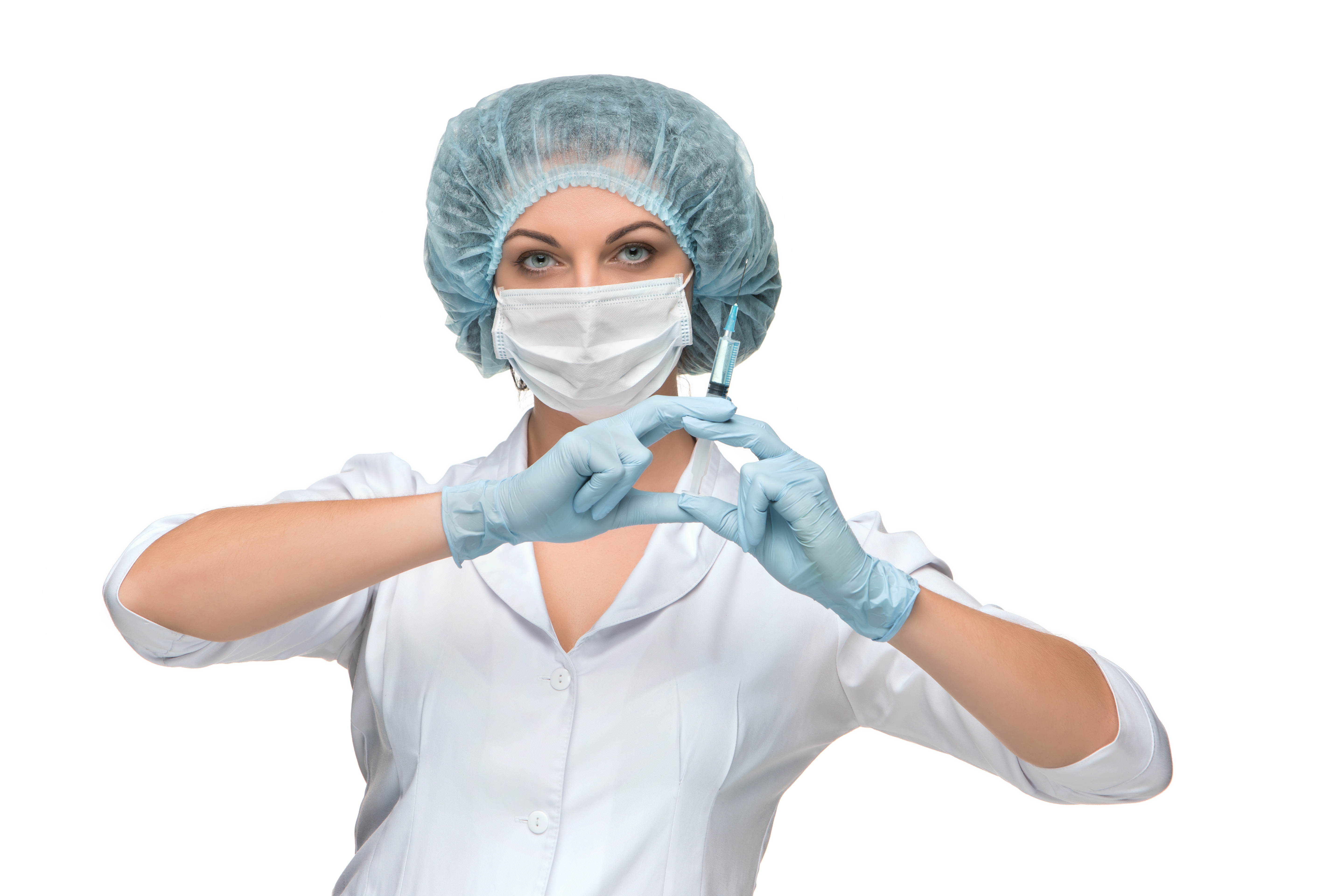 Zastaki.com - Девушка медсестра в маске со шприцем в руках на белом фоне