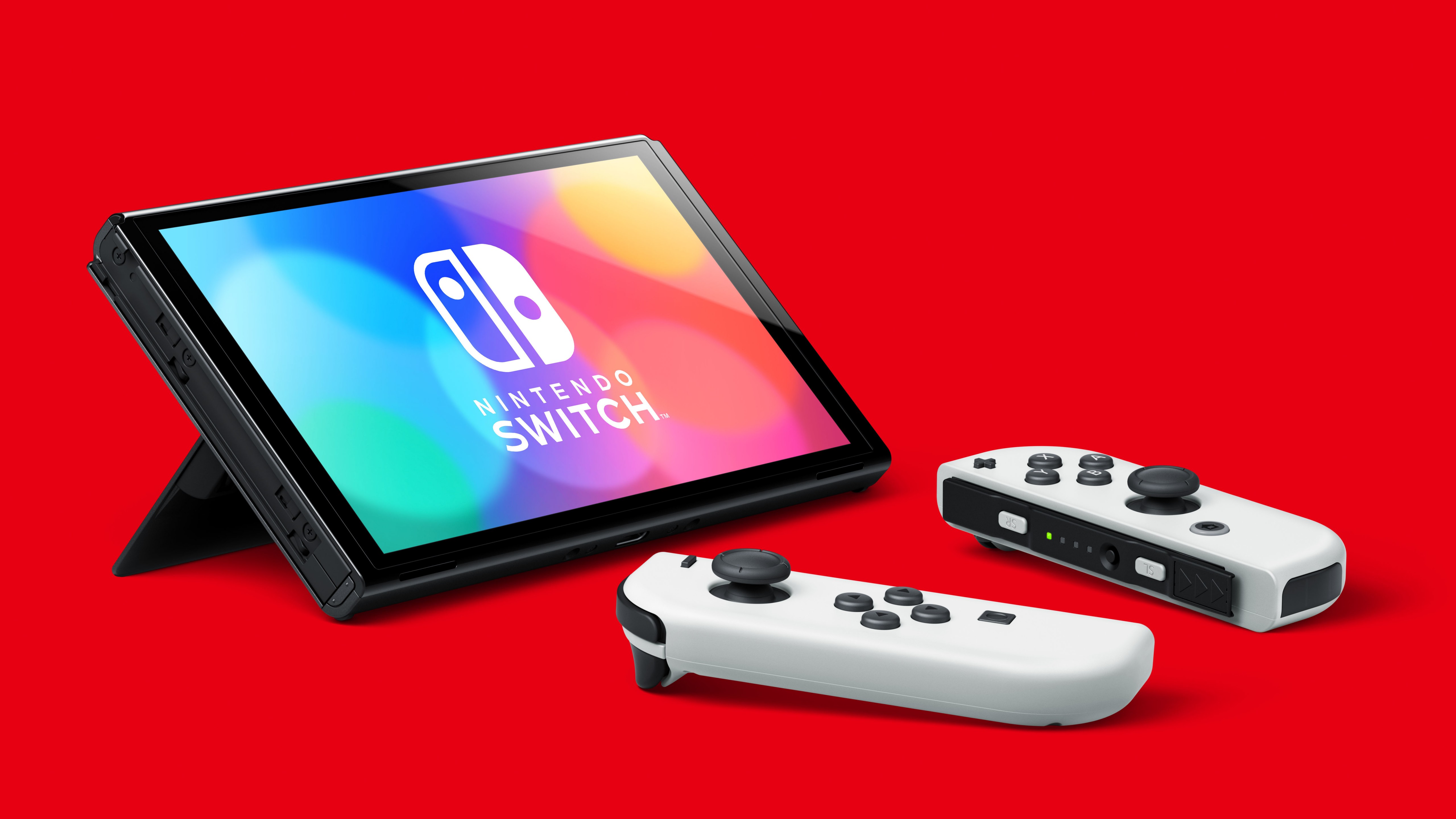 Zastaki.com - Игровая консоль  Nintendo Switch OLED на красном фоне