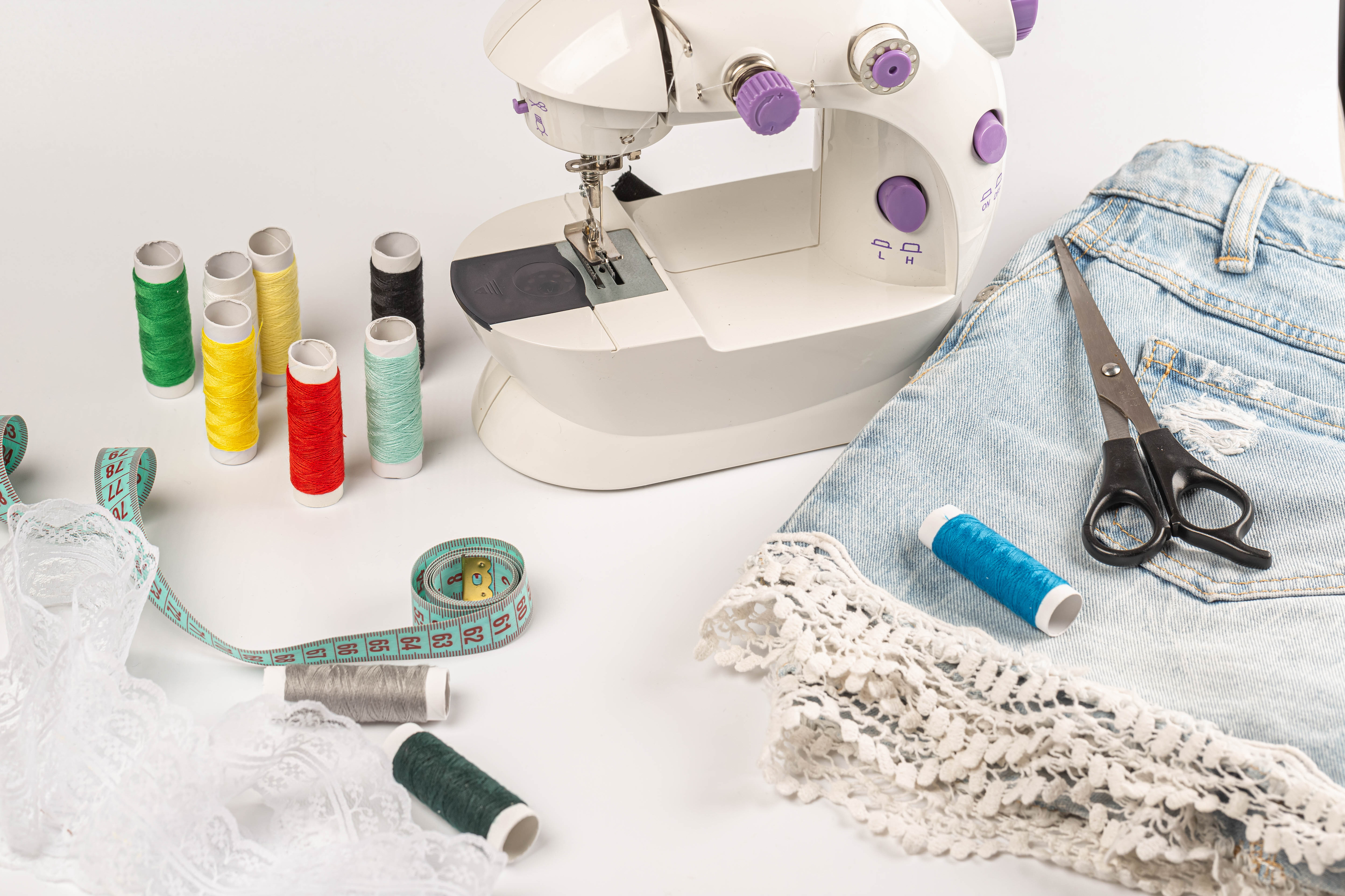 Sewing machine, skirt and thread on a white background Desktop wallpapers  1440x900